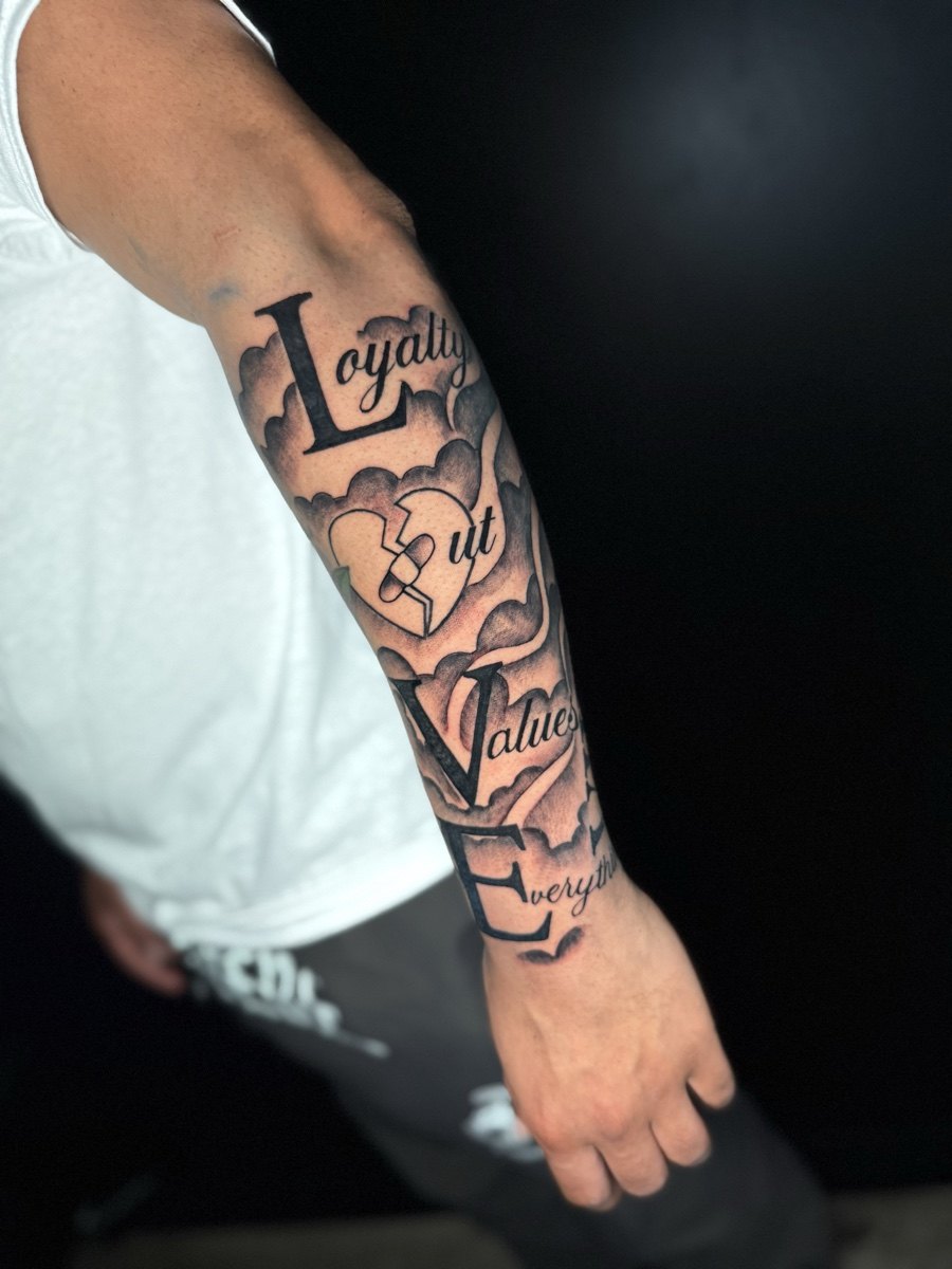 Illustrative patchwork tattoo sleeve with bold outlined motifs.
