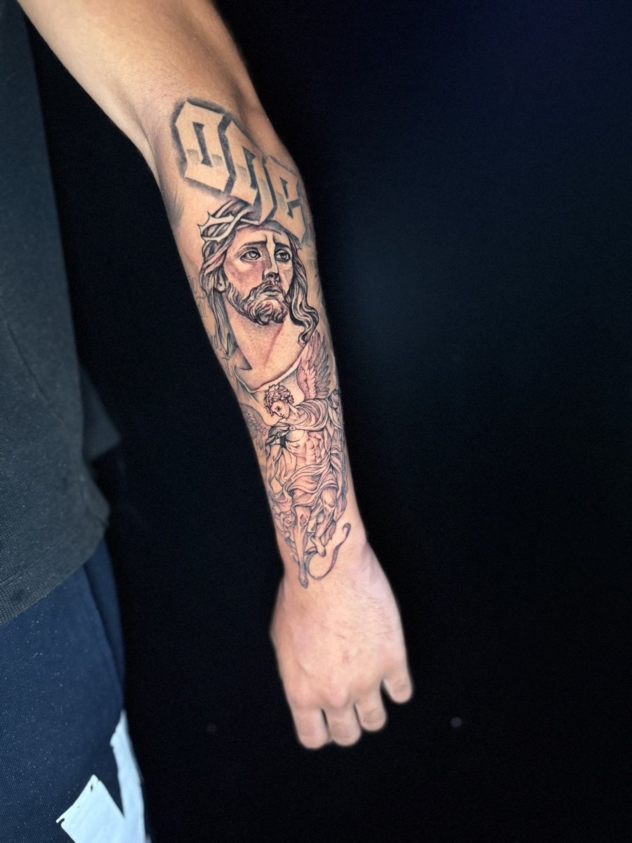 Color comic-inspired collage tattoo on a forearm.