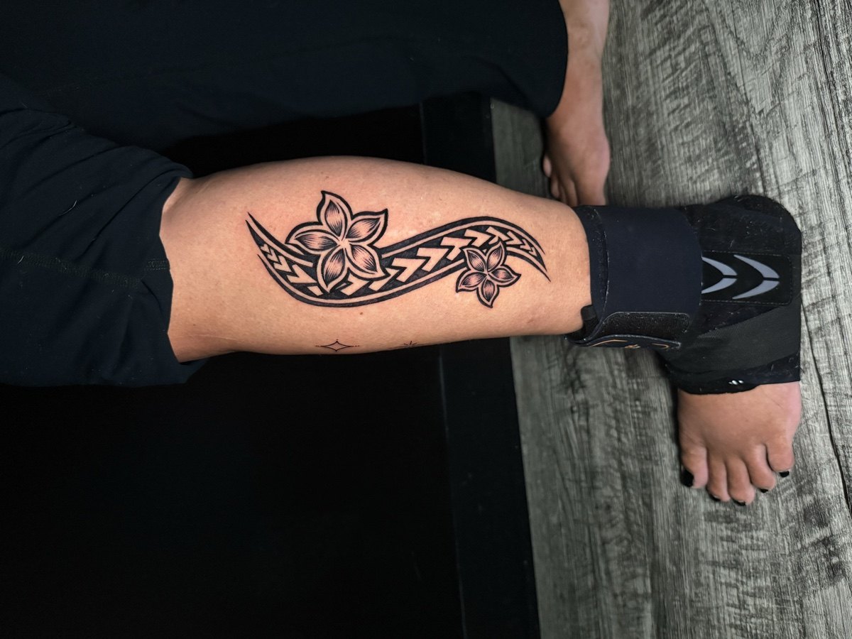 Ornamental floral tattoo centered on a forearm.